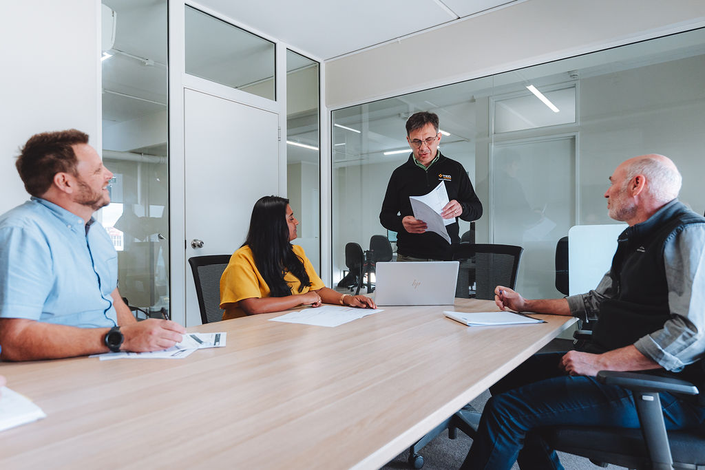 TEG Projects' Team Members in boardroom discussing project